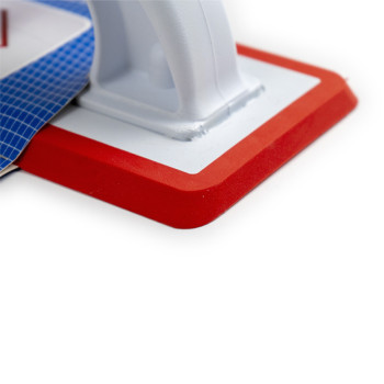 Une truelle à jointoyer rouge et blanche est attachée à une carte d'emballage bleue. Le texte comprend : « COLOTOOL LLANA DE REJ