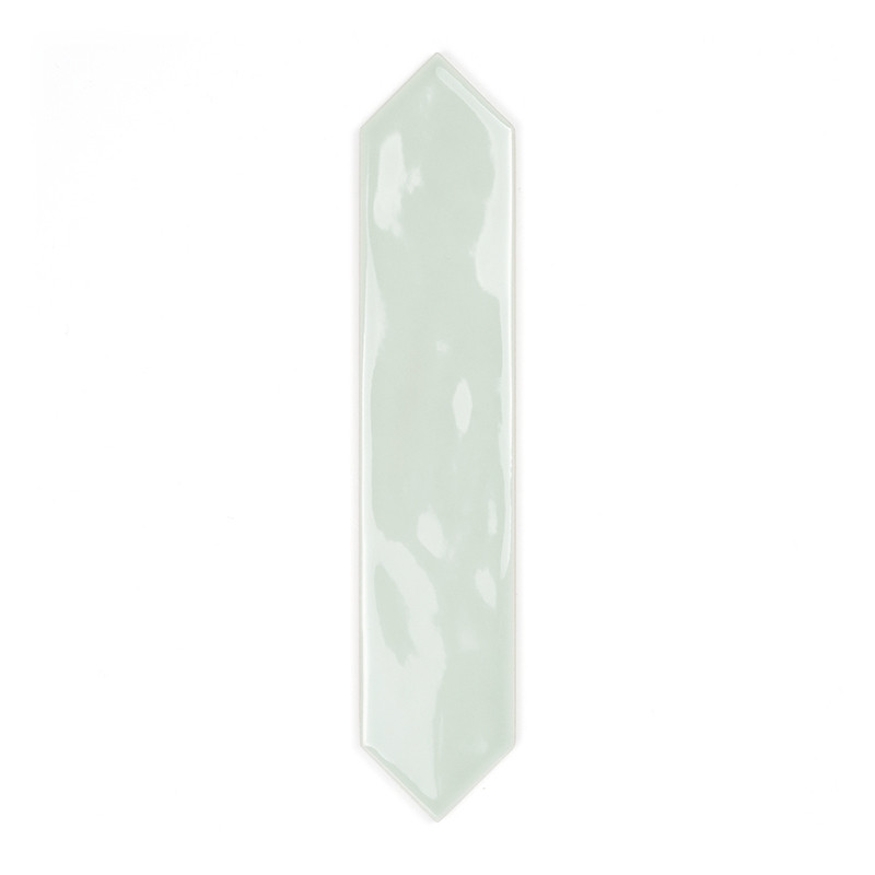 A glossy, elongated, pale-green tile with pointed ends rests on a plain white background, highlighting its sleek, modern design.