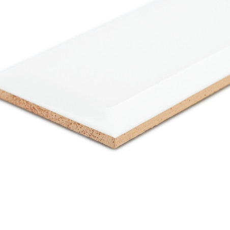 A rectangular, smooth, white ceramic tile with angled edges lies flat on a plain, neutral background, highlighting its sleek fin