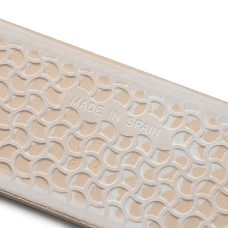 Superficie con textura beige con semicírculos superpuestos en relieve que muestran `MADE IN SPAIN`, lo que sugiere artesanía en Superficie con textura beige con semicírculos superpuestos en relieve que muestran `MADE IN SPAIN`, lo que sugiere artesanía en