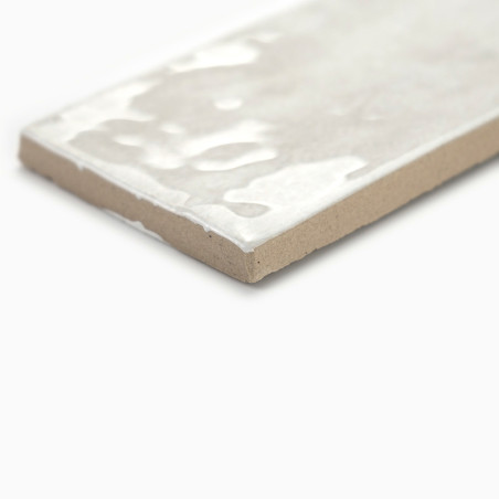 Un carreau rectangulaire repose sur une surface plane, son dessus blanc brillant réfléchissant la lumière, contrasté par un bord Un carreau rectangulaire repose sur une surface plane, son dessus blanc brillant réfléchissant la lumière, contrasté par un bord