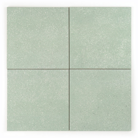 Cuatro mosaicos cuadrados de color verde claro forman una cuadrícula perfecta y cada mosaico muestra un sutil patrón moteado. El Cuatro mosaicos cuadrados de color verde claro forman una cuadrícula perfecta y cada mosaico muestra un sutil patrón moteado. El