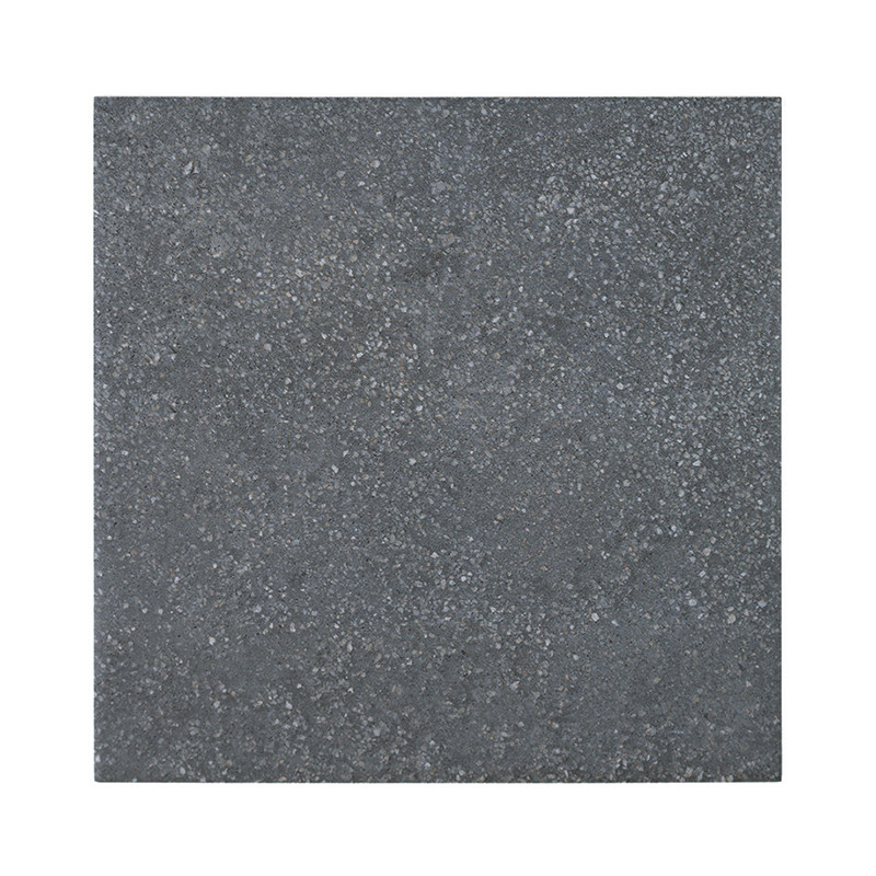 A square tile, with a textured, dark gray surface, rests against a plain white background.