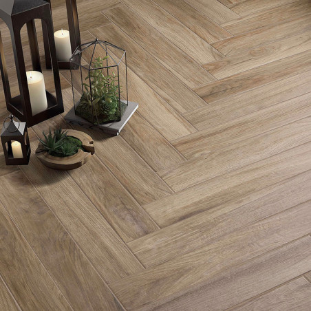 Wooden-patterned tiles laid in a herringbone style cover the floor, surrounded by lanterns and small potted plants for decoratio