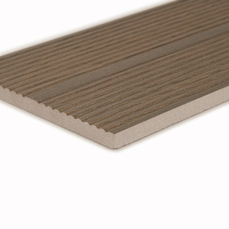 A rectangular, wood-textured tile with thin parallel grooves rests on a light background. The edges appear smooth and tapered.