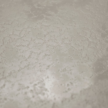 Le carreau présente une surface subtile et texturée avec des motifs géométriques irréguliers ressemblant à des hexagones et des 