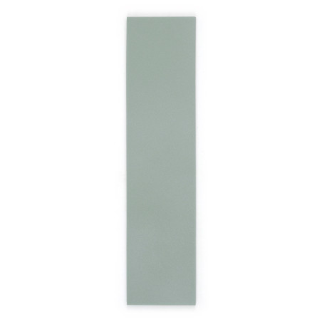 A long, rectangular, light green tile stands upright against a plain white background, highlighting its smooth and matte surface