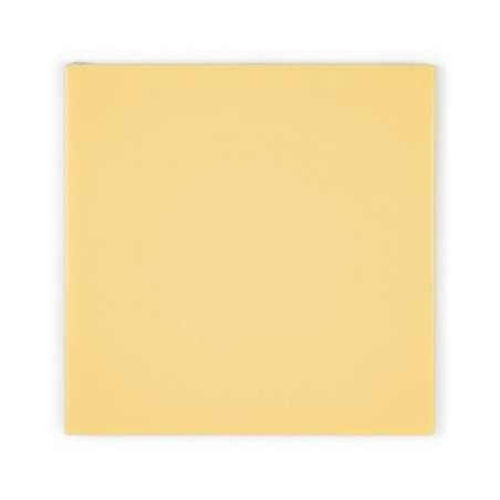 A plain, light yellow square tile sits on a white background, emphasizing its smooth, uniform surface and minimalist aesthetics.