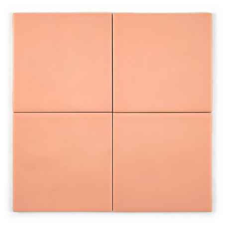 Four peach-colored ceramic tiles are arranged in a square formation, with slight shadows between each tile, set on a plain backg