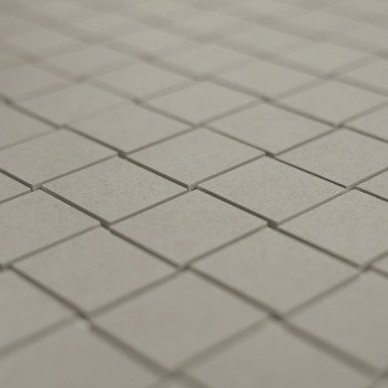 Gray square tiles are arranged in a neat, repeating grid pattern on a flat surface, creating a uniform, minimalist design.