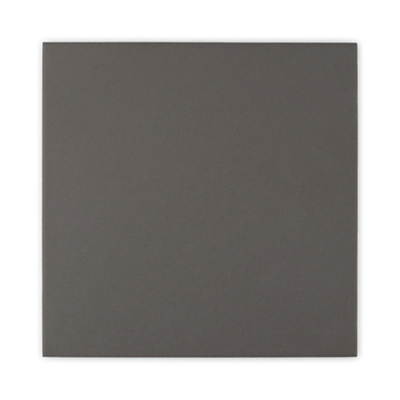 A dark, solid-colored square tile resting against a plain white background.