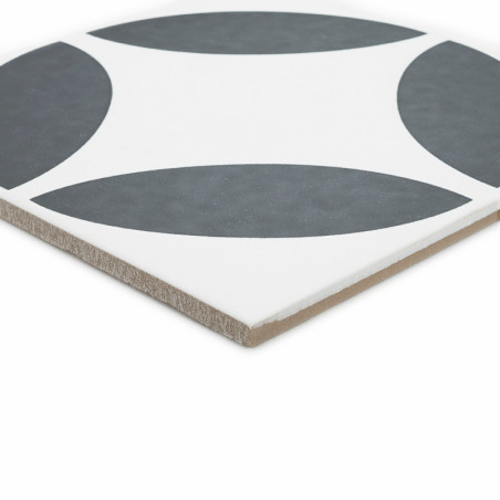 Um ladrilho cerâmico quadrado apresenta um padrão de quatro quartos de círculo cinza escuro sobre um fundo branco, formando um d