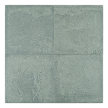 Four square, matte tiles arranged together, displaying a light bluish-gray color with subtle textured patterns. no text is visib