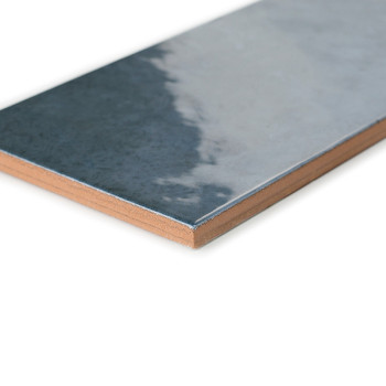 Un carreau de céramique rectangulaire avec une surface brillante et réfléchissante passe du gris foncé au gris clair. présenté s