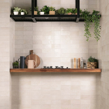 Des carreaux muraux blancs et rectangulaires forment une toile de fond de cuisine avec une étagère en bois. Sur l'étagère, les u