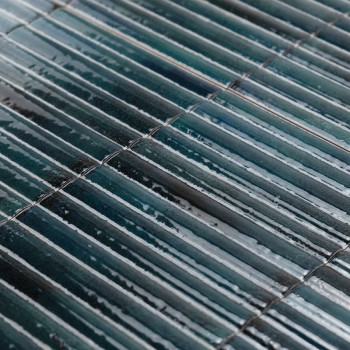 Rectangular, glossy tiles are arranged in parallel rows, displaying a gradient of dark green and blue shades, reflecting light s