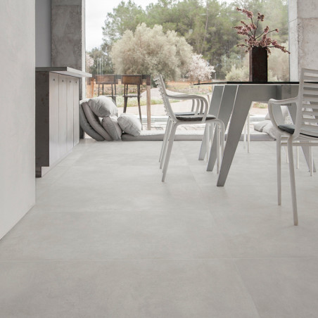 Lichtgrijze vloertegels creëren een naadloze, moderne uitstraling in een ruime kamer met witte stoelen en een tafel, met weelder Lichtgrijze vloertegels creëren een naadloze, moderne uitstraling in een ruime kamer met witte stoelen en een tafel, met weelder