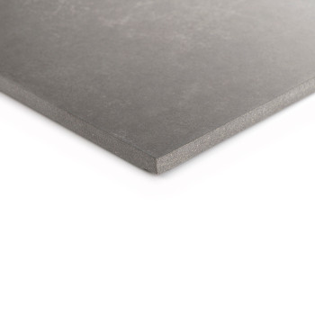 A gray ceramic tile sits angled on a white background, showcasing its smooth surface and slightly beveled edges.