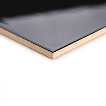 A glossy black tile with beige edges rests on a white background, showcasing its smooth surface and clean, sharp corner.
