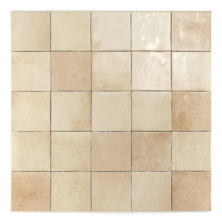 A grid of 25 beige square tiles varies subtly in shade, arranged symmetrically, displaying a smooth, matte finish in a neutral s