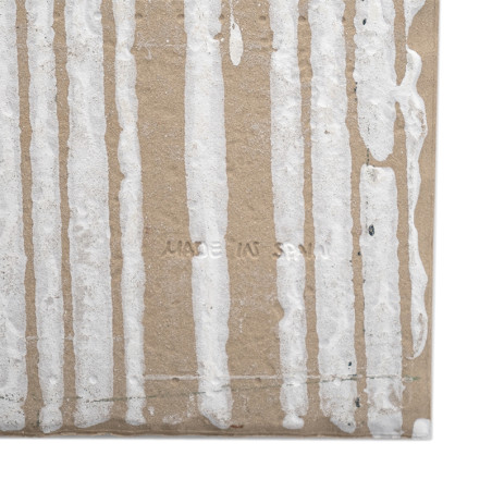 Vertical white drips adorn a textured, brown tile background. The text `MADE IN SPAIN` is subtly stamped into the surface.