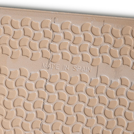 Tan tile features raised, crescent-shaped patterns with slightly uneven texture. Center text reads `MADE IN SPAIN,` indicating i Tan tile features raised, crescent-shaped patterns with slightly uneven texture. Center text reads `MADE IN SPAIN,` indicating i
