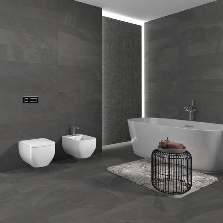 Ein modernes Badezimmer verfügt über eine große weiße Badewanne neben einer dunklen Steinwand und einen runden Drahttisch auf ei