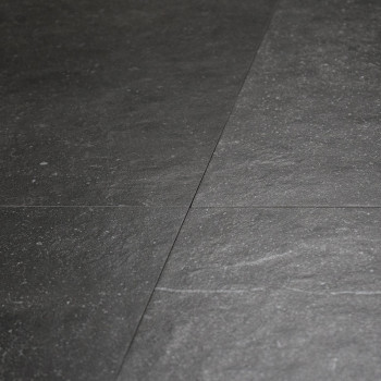 Dark slate tiles form a smooth, textured surface with subtle variations in tone, creating a natural, sophisticated flooring patt