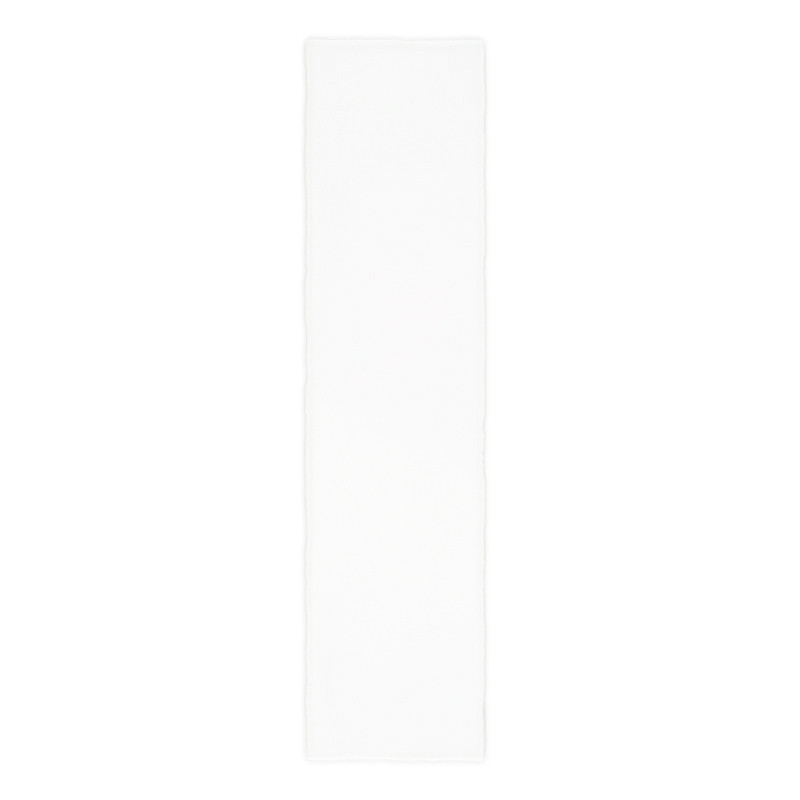 A rectangular white tile rests horizontally, displaying a smooth, glossy surface. It is set against a plain, white background.