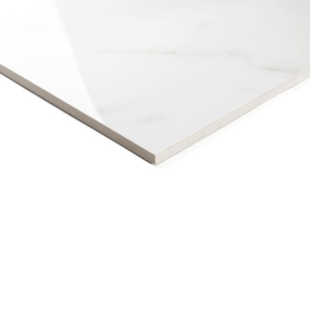 A glossy, white ceramic tile with subtle gray veining lies flat, corner visible, on a plain white background. No text appears.