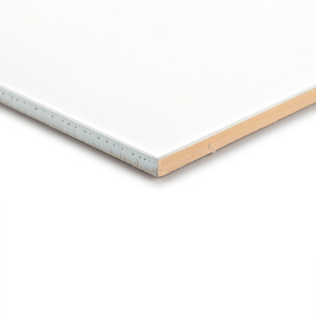 A white ceramic tile rests on a flat surface, showcasing its smooth edge and light brown underside in a bright setting. A white ceramic tile rests on a flat surface, showcasing its smooth edge and light brown underside in a bright setting.