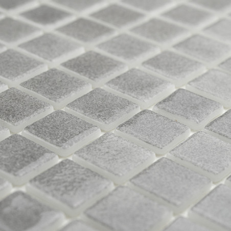 Square glass tiles shimmer subtly, forming a textured mosaic pattern. arranged neatly in an evenly spaced grid.