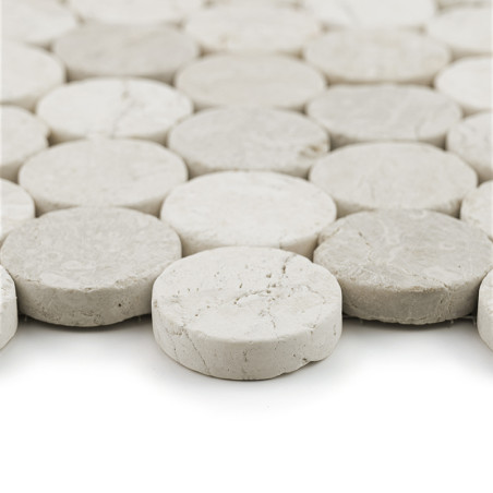 Circular stone tiles arranged closely together, forming a cohesive, textured surface in a uniform, light gray color. Circular stone tiles arranged closely together, forming a cohesive, textured surface in a uniform, light gray color.