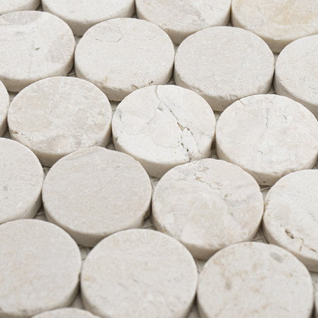 Round stone tiles are arranged closely together, forming a textured, seamless surface. The context is a uniform background. Round stone tiles are arranged closely together, forming a textured, seamless surface. The context is a uniform background.