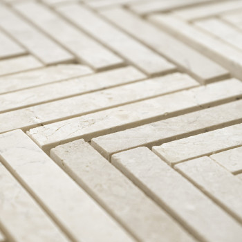 Les carreaux de pierre rectangulaires forment un motif géométrique imbriqué sur une surface plane, créant une mosaïque texturée 