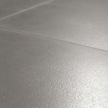Ceramic tiles, positioned closely, create a seamless surface with a light gray, subtly textured finish, suitable for flooring or