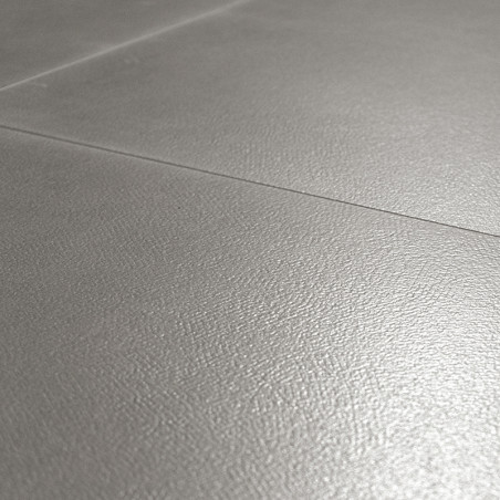 Ceramic tiles, positioned closely, create a seamless surface with a light gray, subtly textured finish, suitable for flooring or