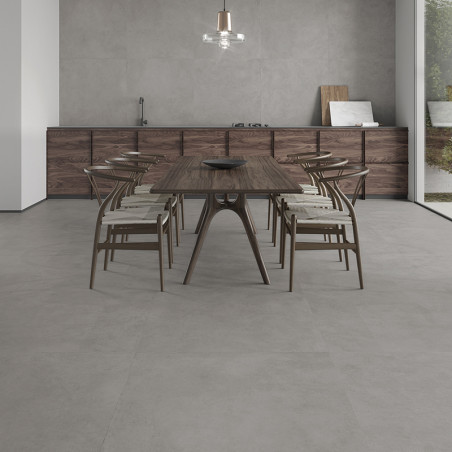 A wooden dining table with chairs stands on a smooth, light gray tile floor in a modern kitchen with minimalist decor.