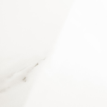 A white tile, featuring subtle gray veins, rests in soft lighting, creating an elegant and minimalist appearance suitable for mo