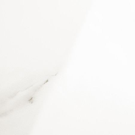 A white tile, featuring subtle gray veins, rests in soft lighting, creating an elegant and minimalist appearance suitable for mo