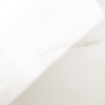 A smooth white marble tile with subtle gray veining diagonally extends across a flat, well-lit surface, giving an impression of 