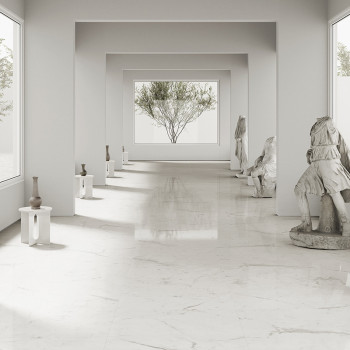 Marble statues stand in an elegant, light-filled corridor, each positioned on pedestals beside smooth, reflective floors. Large 