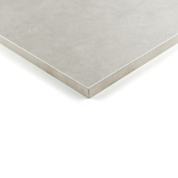 Eine quadratische, mattgraue Fliese liegt auf einer weißen Oberfläche, deren scharfe Kanten ein klares, minimalistisches Design 