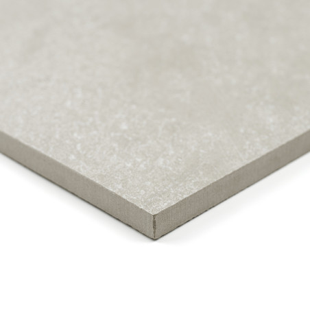 A square, light gray tile with a smooth texture rests on a white background, showcasing its thin, straight edges.