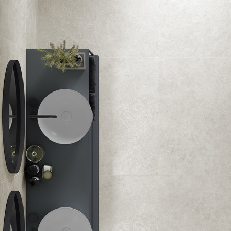 A sleek, rectangular bathroom counter holds two circular sinks with modern faucets. Above, mirrors are placed. the wall features