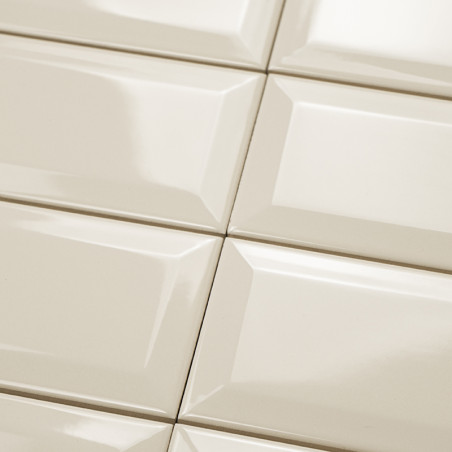 Ceramic tiles arranged in a grid pattern, reflecting light, creating a glossy surface in an indoor setting.
