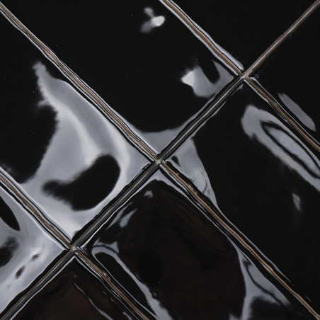 Glossy black ceramic tiles reflect light, creating a sleek appearance in a grid pattern. The surrounding area is indistinct. Glossy black ceramic tiles reflect light, creating a sleek appearance in a grid pattern. The surrounding area is indistinct.
