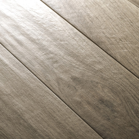 The tile features a wood-like texture with subtle grain patterns, aligned in planks, creating a natural, rustic flooring appeara