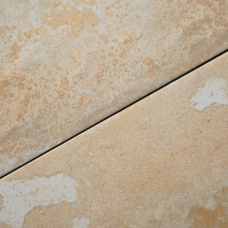 Ceramic tiles arranged diagonally show a light beige color with subtle, textured speckles. The tiles create a smooth surface in 