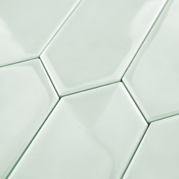 Hexagonal tiles fit together seamlessly, creating a continuous pattern. They feature a glossy mint-green finish, reflecting ligh
